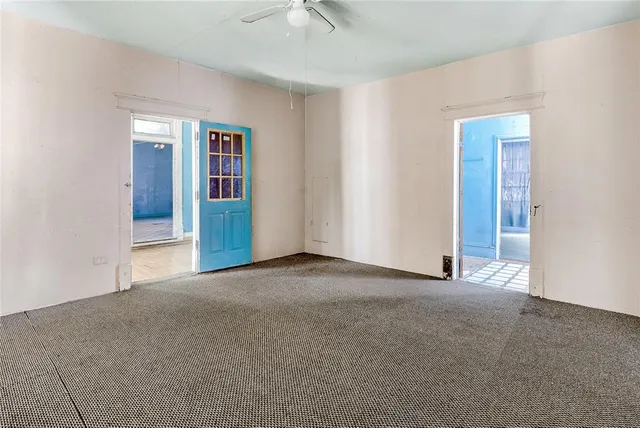 a view of an empty room with closet and a window