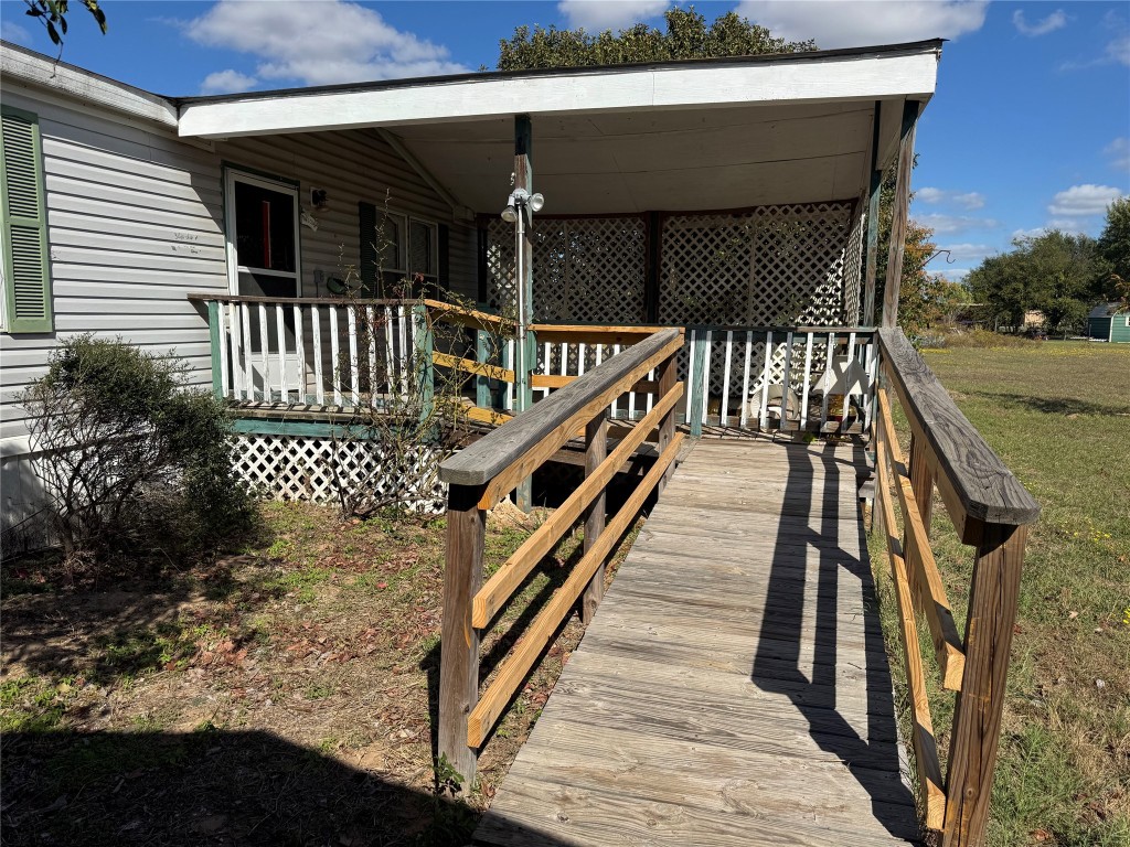 a balcony with wooden floor and outdoor seating
