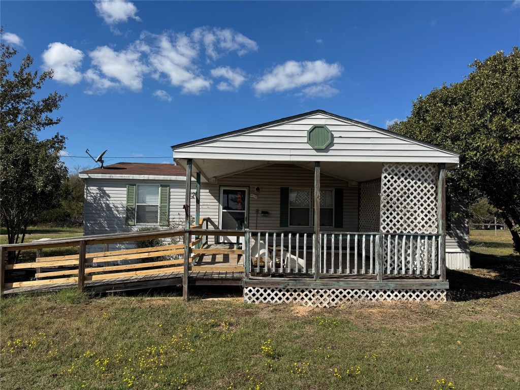 114 Speir Lane, Unit B Elgin, TX 78621 - Photo 3 of 11 a front view of a house with a garden
