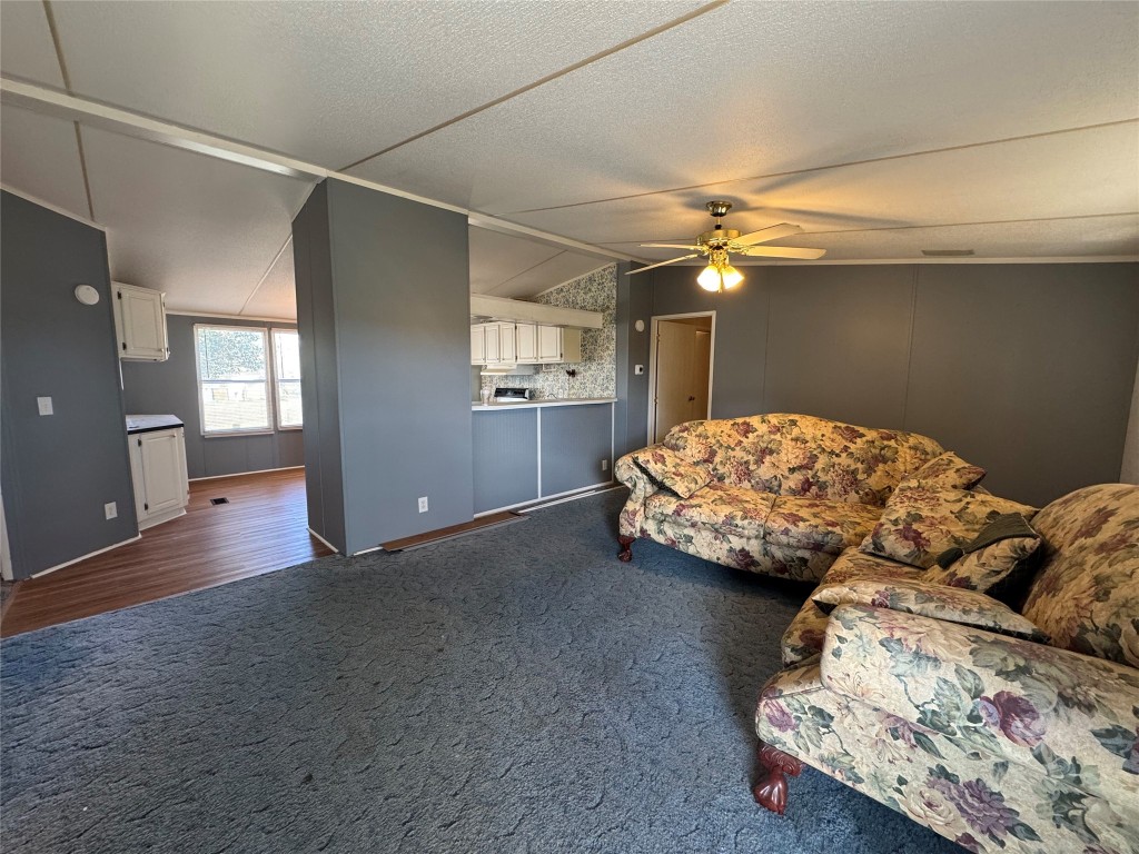 114 Speir Lane, Unit B Elgin, TX 78621 - Photo 4 of 11 a bedroom with a bed and a chandelier