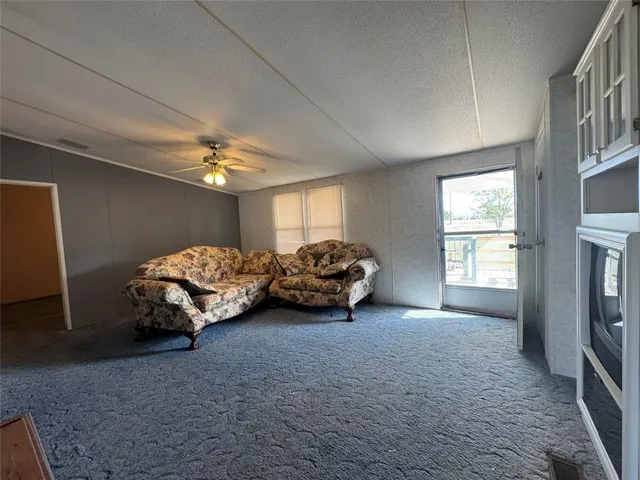 a spacious bedroom with a bed and a chandelier