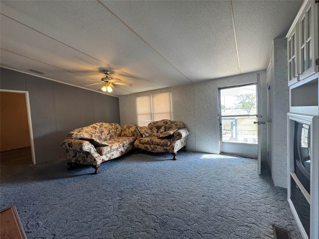 114 Speir Lane, Unit B Elgin, TX 78621 - Photo 6 of 11 a spacious bedroom with a bed and a chandelier