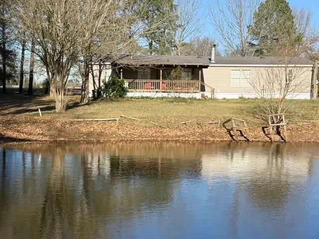 a view of a lake with a house swimming pool and outdoor space