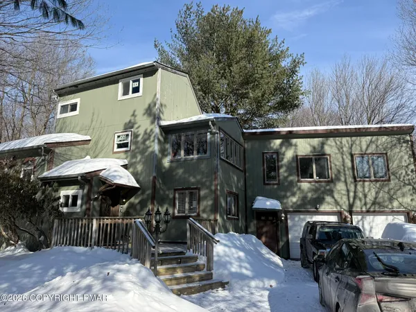 a front view of a house with parking
