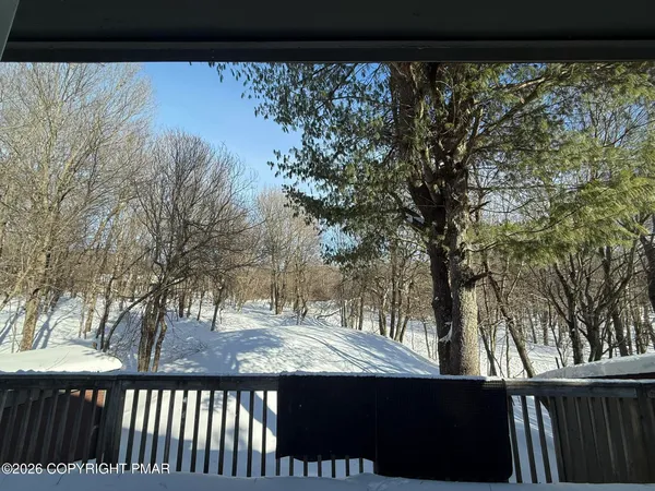 a view of a dining room and livingroom with furniture window and wooden floor