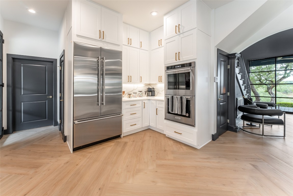 12605 Fitzhugh Road Austin, TX 78736 - Photo 14 of 40 a kitchen with stainless steel appliances a refrigerator and a stove top oven