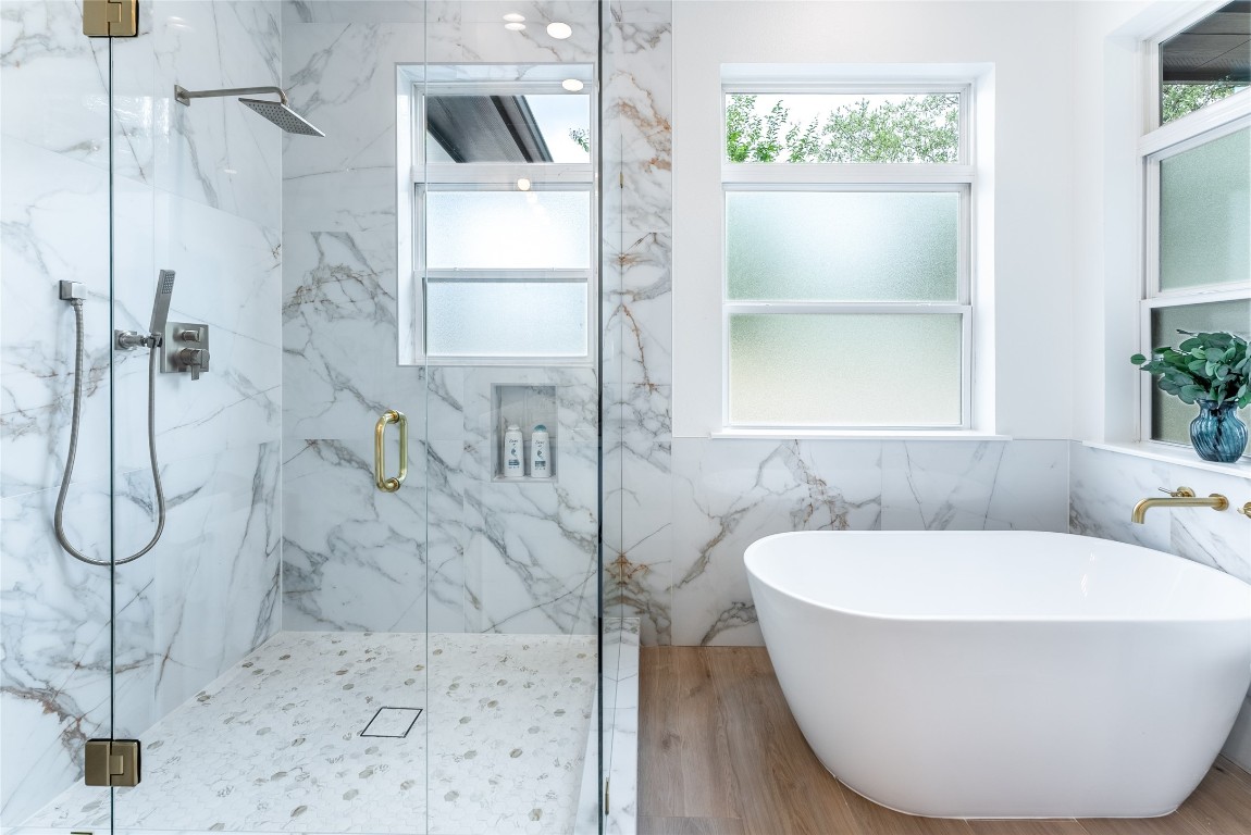 12605 Fitzhugh Road Austin, TX 78736 - Photo 18 of 40 a bathroom with a white bath tub sitting next to a window