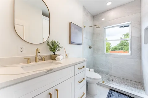 a bedroom with a large bed and a desk