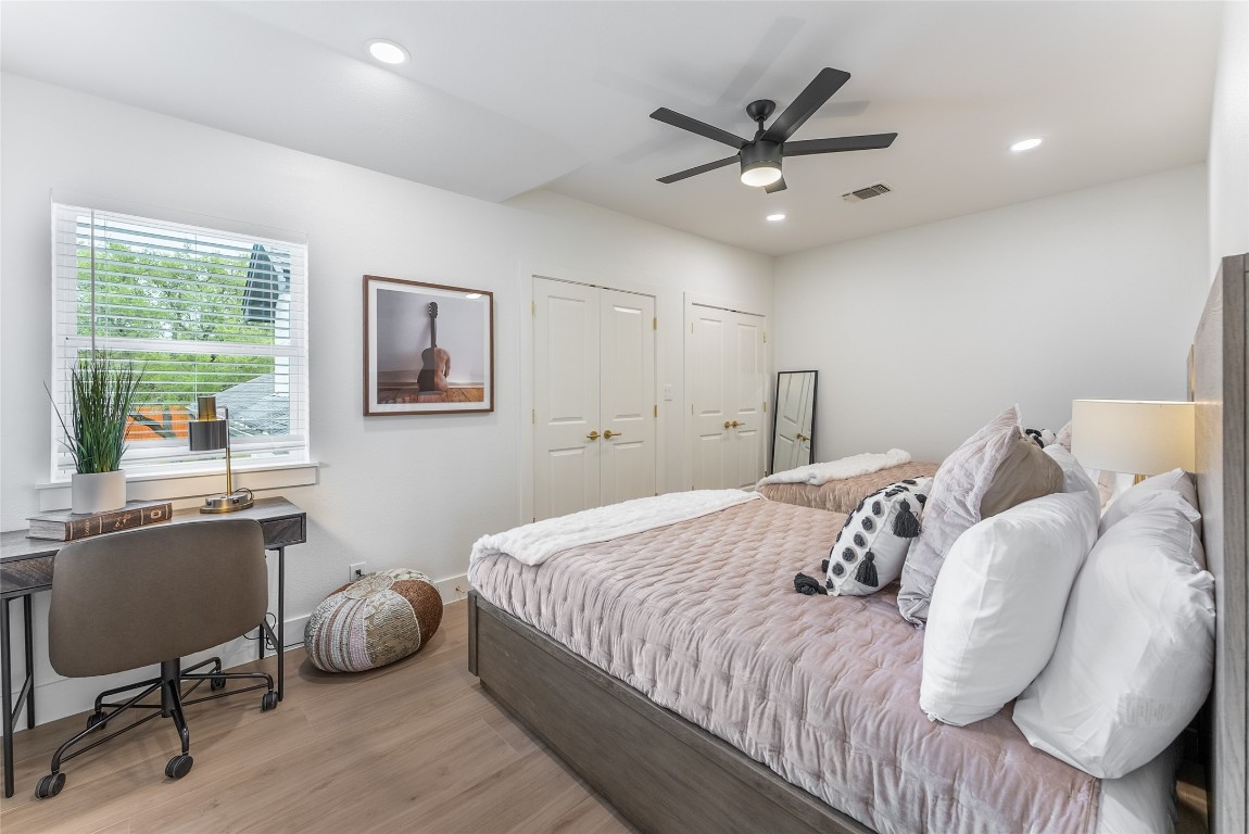 12605 Fitzhugh Road Austin, TX 78736 - Photo 23 of 40 a bedroom with a large bed and a desk