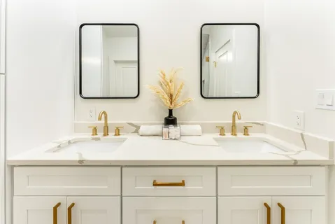 a bathroom with a toilet a sink and mirror