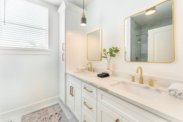 a bathroom with a sink a vanity and a mirror