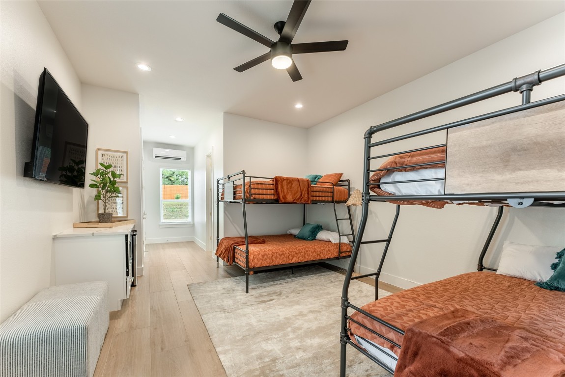 12605 Fitzhugh Road Austin, TX 78736 - Photo 32 of 40 a bedroom with furniture and a flat screen tv