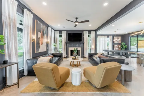 a very nice looking living room with a large window and dining table