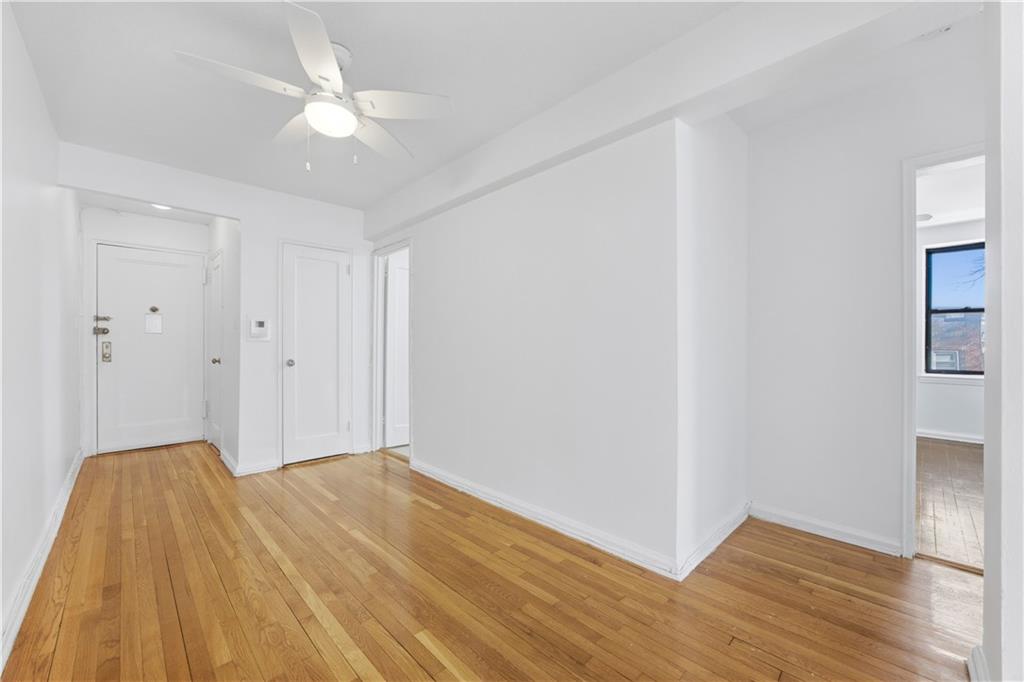 302 96th Street, Unit 3H Brooklyn, NY 11209 - Photo 2 of 14 a view of a room with wooden floor and ceiling fan