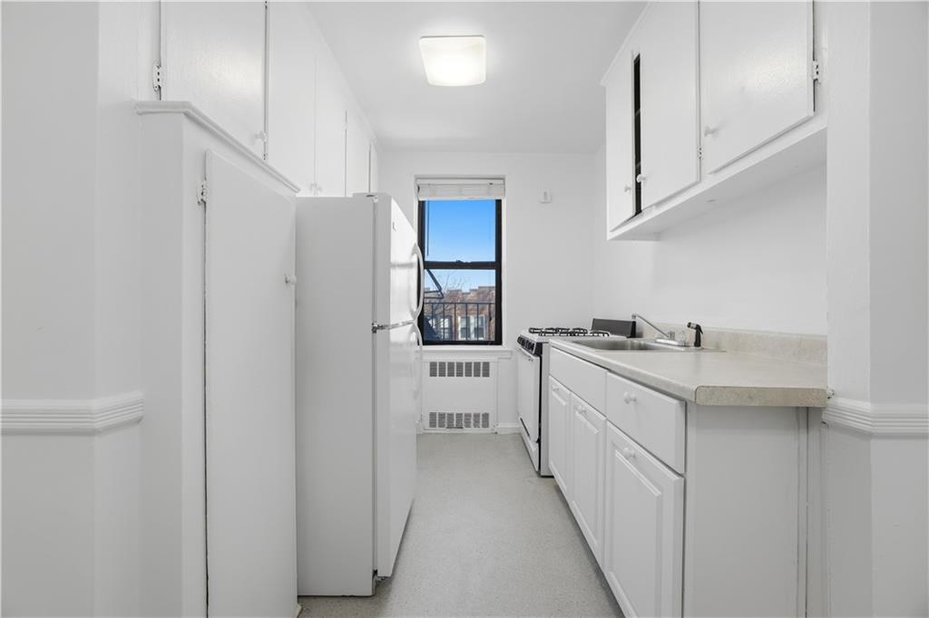 302 96th Street, Unit 3H Brooklyn, NY 11209 - Photo 5 of 14 a bathroom with a sink a mirror and a shower