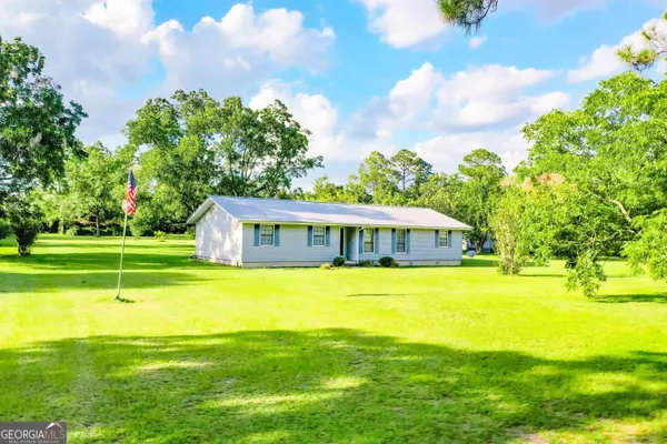 a front view of a house with a big yard
