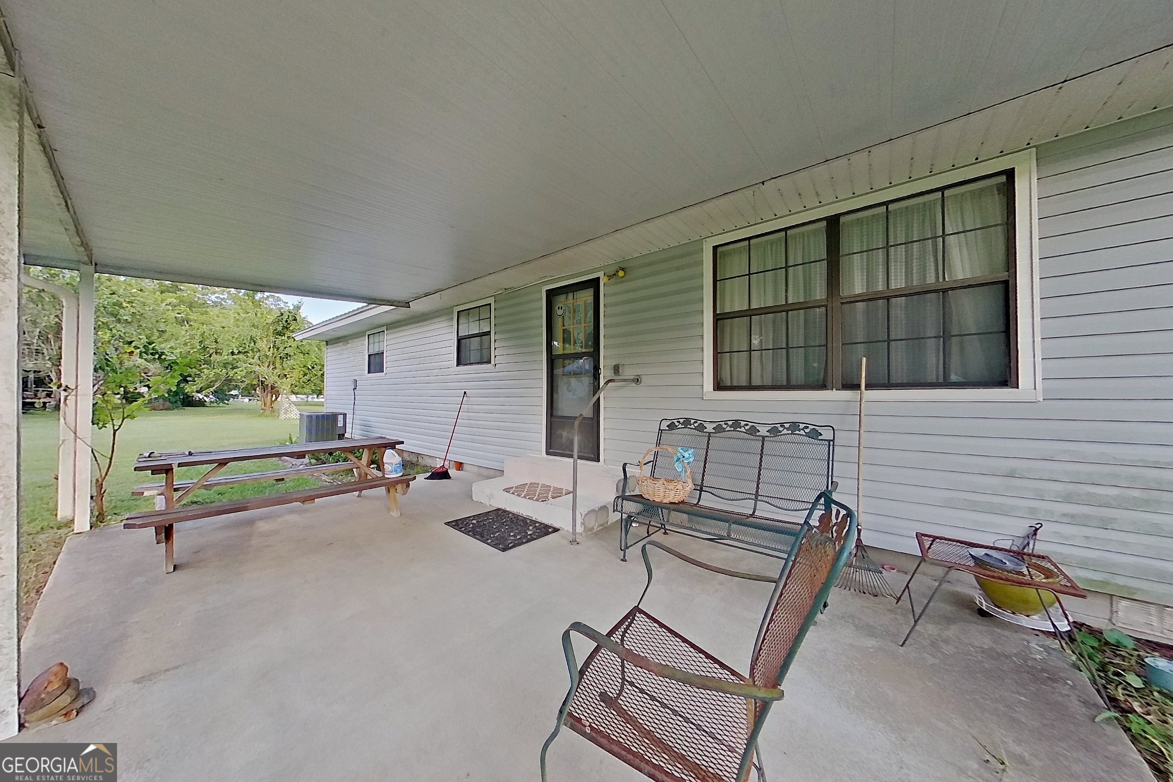 2142 Ben Couch Road Blackshear, GA 31516 - Photo 18 of 43 an outdoor sitting area with couch and wooden floor