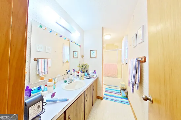 a bathroom with a shower a toilet and a shower curtain