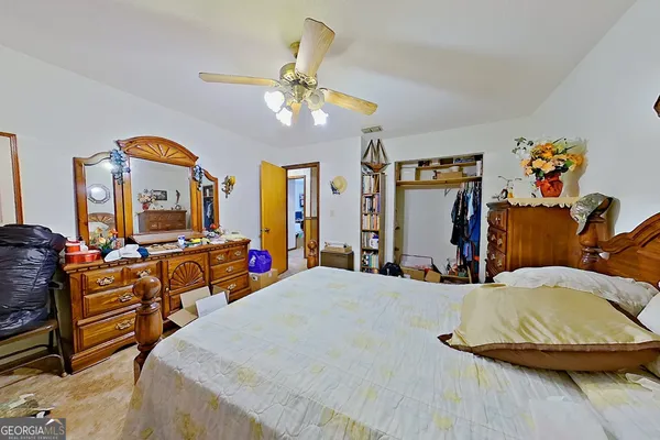 a bedroom with 2 bed and a furniture