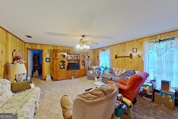 a living room with furniture a window and gym equipment