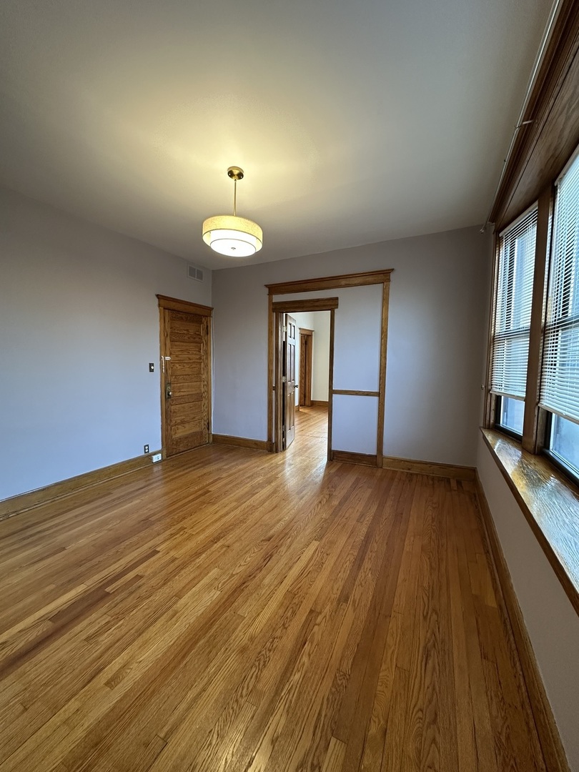 3759 North Damen Avenue, Unit 2 Chicago, IL 60613 - Photo 12 of 22 a view of a room with wooden floor and a window