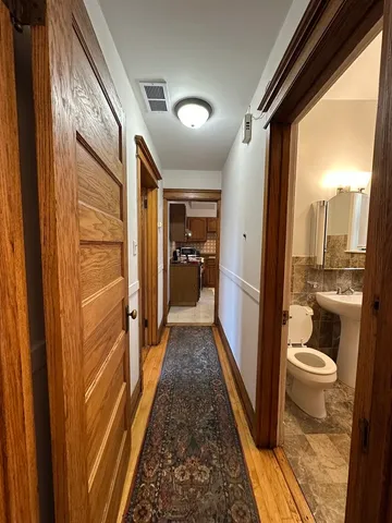 a bathroom with a granite countertop shower a toilet and a sink