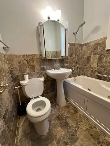 a bathroom with a toilet sink and mirror
