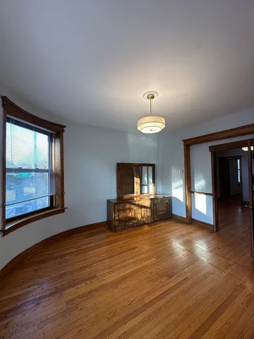 a view of a livingroom with furniture a fireplace and wooden floor
