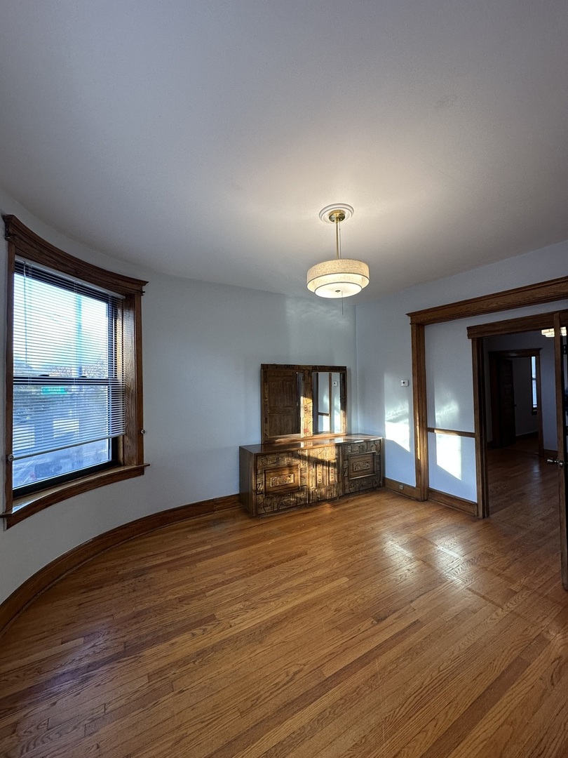 3759 North Damen Avenue, Unit 2 Chicago, IL 60613 - Photo 10 of 22 a view of a livingroom with furniture a fireplace and wooden floor