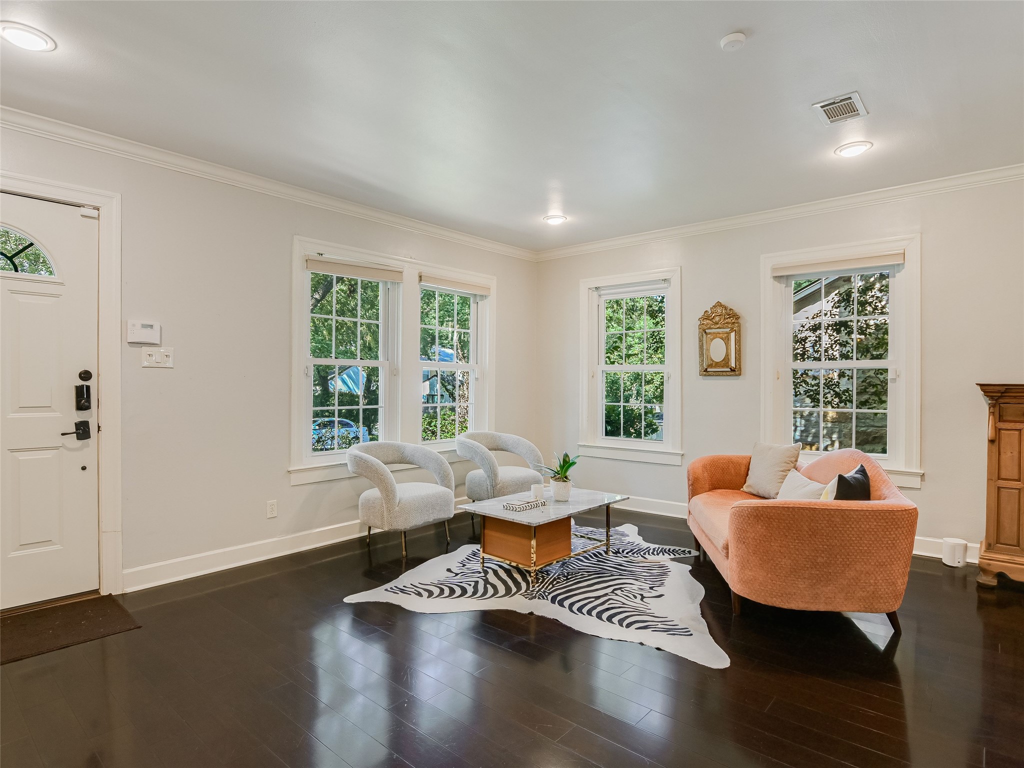 1804 Polo Road Austin, TX 78703 - Photo 8 of 19 Living room featuring plenty of natural light, dark wood-type flooring, and ornamental molding