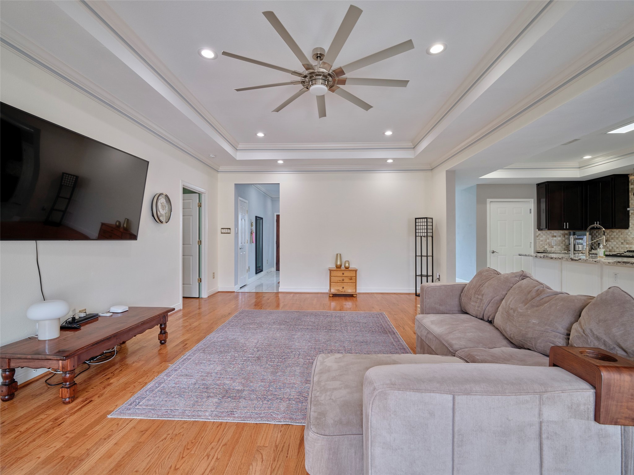 4219 Redbud Street Houston, TX 77051 - Photo 7 of 25 This gorgeous family room offers a perfect blend of elegance and comfort, featuring a spacious layout, modern finishes, and abundant natural light, ideal for both relaxation and entertainment.