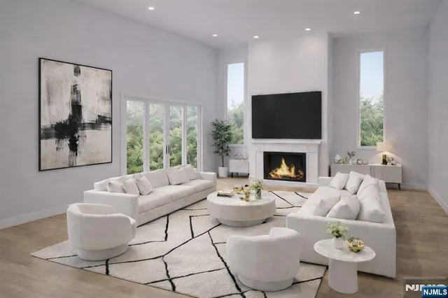 a living room with furniture a flat screen tv and a fireplace
