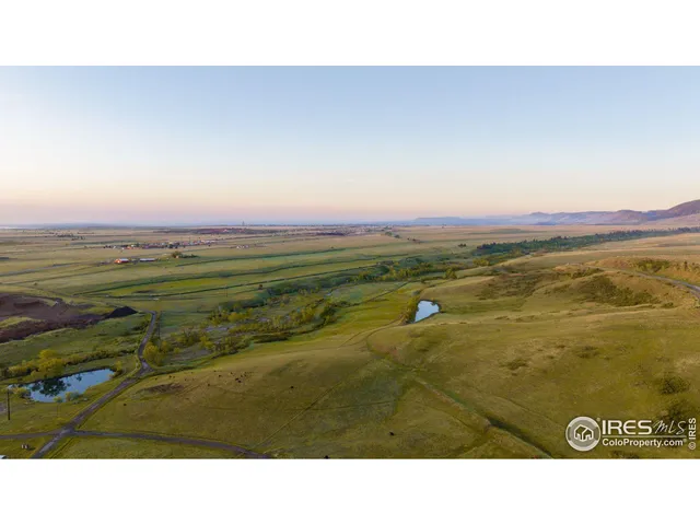a open area with mountains in the background