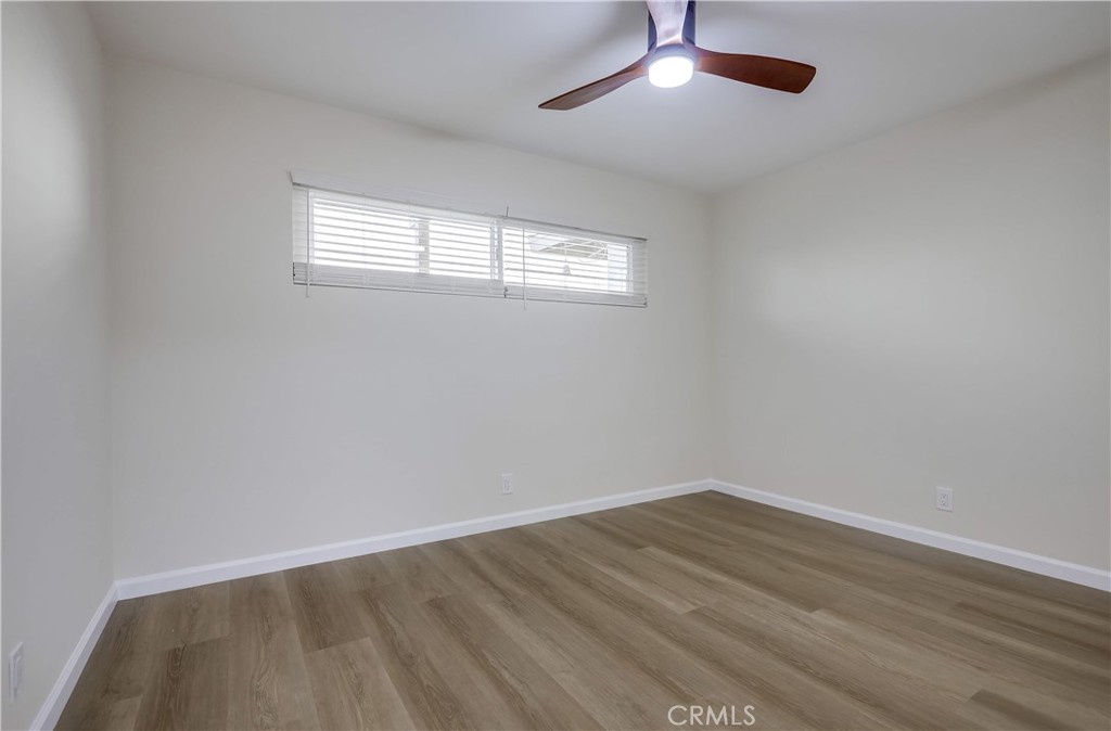 142 Avenida Pelayo, Unit B San Clemente, CA 92672 - Photo 14 of 26 an empty room with wooden floor and windows