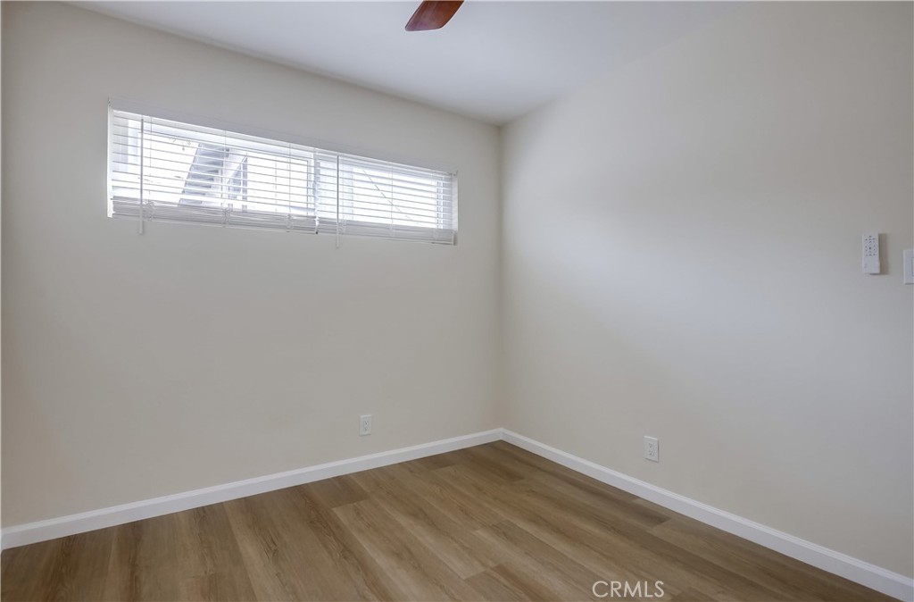 142 Avenida Pelayo, Unit B San Clemente, CA 92672 - Photo 20 of 26 a view of an empty room with wooden floor and a window