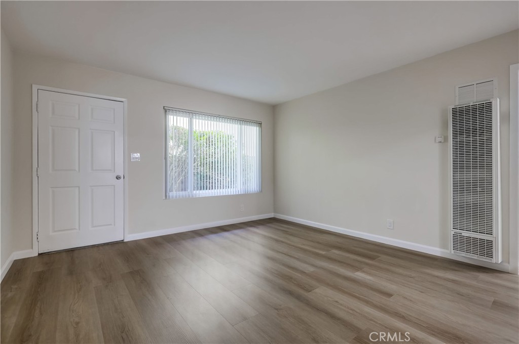 142 Avenida Pelayo, Unit B San Clemente, CA 92672 - Photo 5 of 26 an empty room with wooden floor and windows