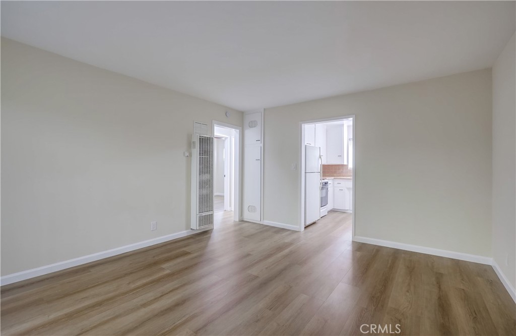 142 Avenida Pelayo, Unit B San Clemente, CA 92672 - Photo 8 of 26 a view of an empty room with wooden floor and a window