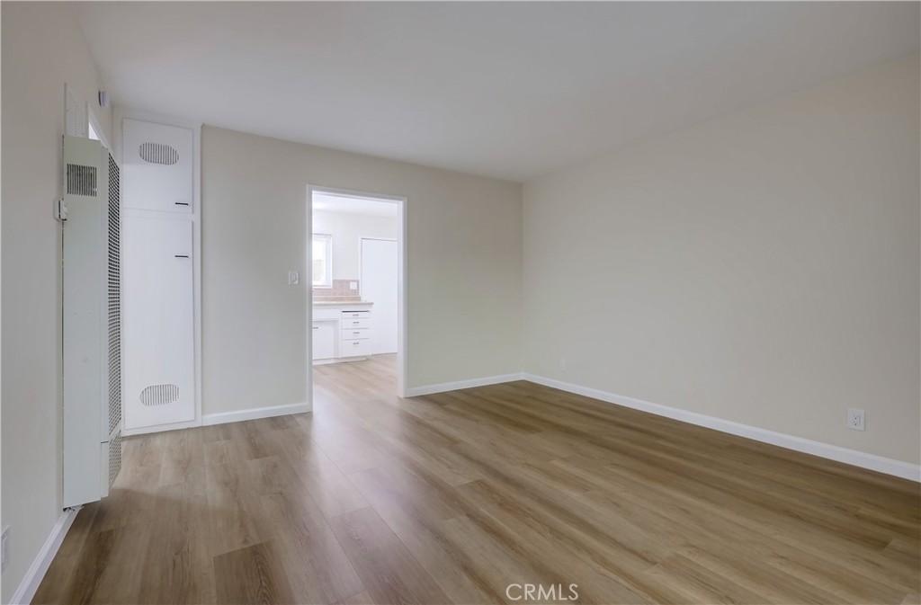 142 Avenida Pelayo, Unit B San Clemente, CA 92672 - Photo 9 of 26 a view of an empty room with wooden floor and a window