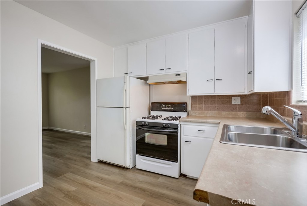 142 Avenida Pelayo, Unit B San Clemente, CA 92672 - Photo 10 of 26 a kitchen with granite countertop a sink and a stove top oven