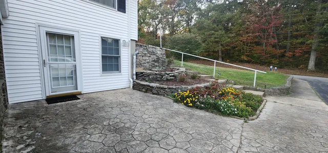 a view of a chair and table in the backyard