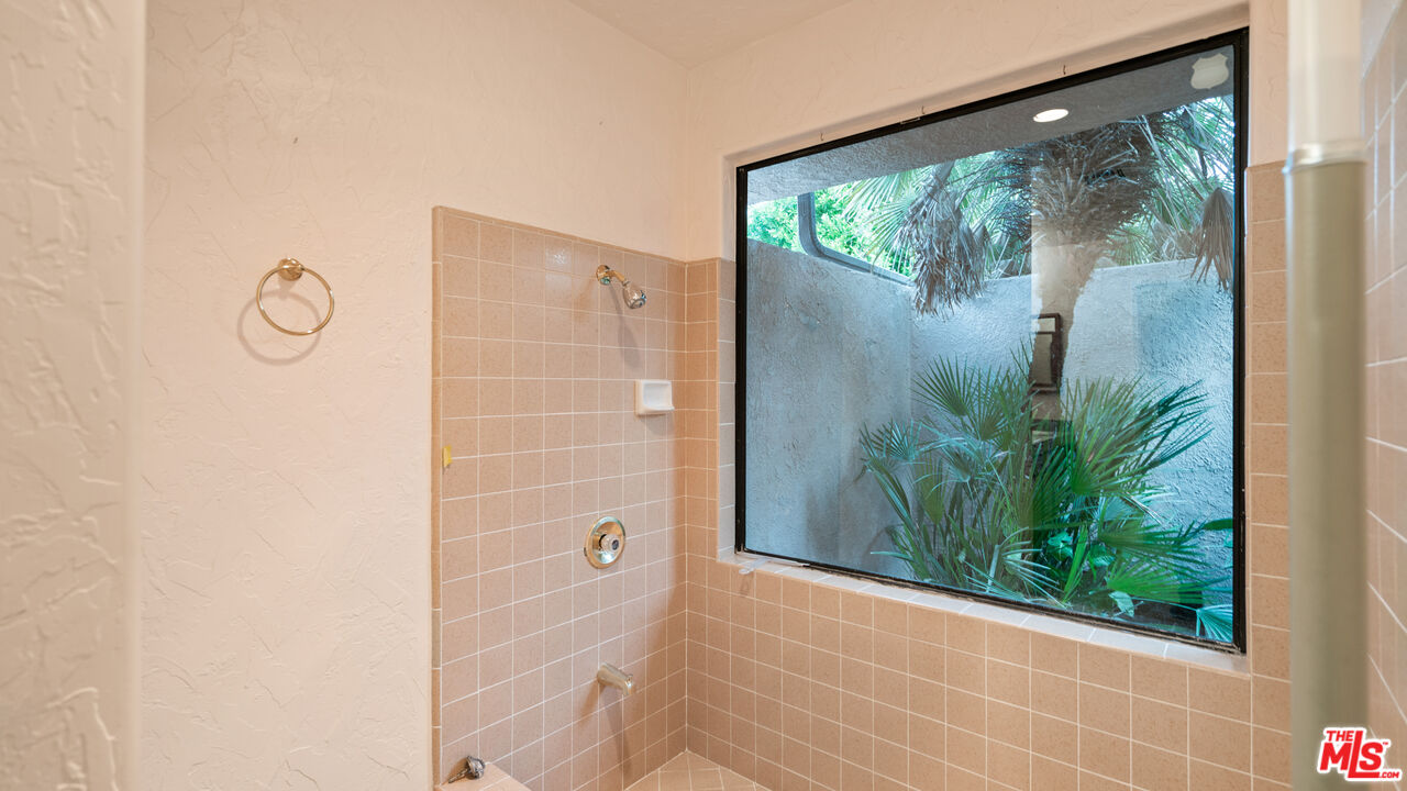1592 South Compadre Road Palm Springs, CA 92264 - Photo 22 of 53 a view of a glass door with a yard from a window