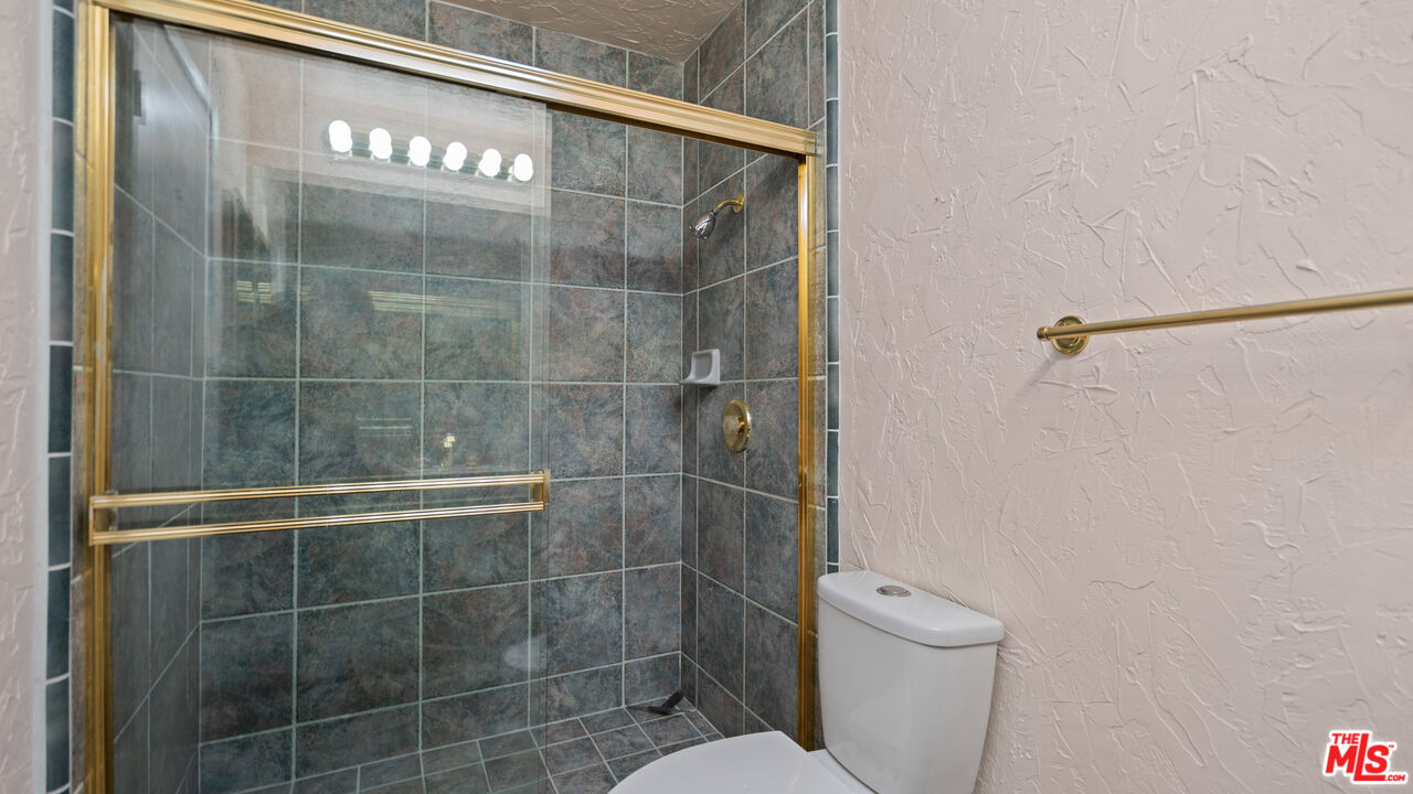 1592 South Compadre Road Palm Springs, CA 92264 - Photo 29 of 53 a bathroom with a toilet and a shower