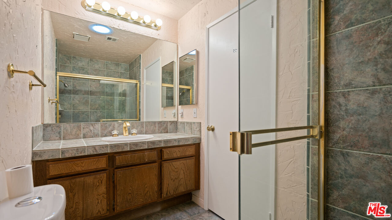 1592 South Compadre Road Palm Springs, CA 92264 - Photo 30 of 53 a bathroom with a sink and mirror