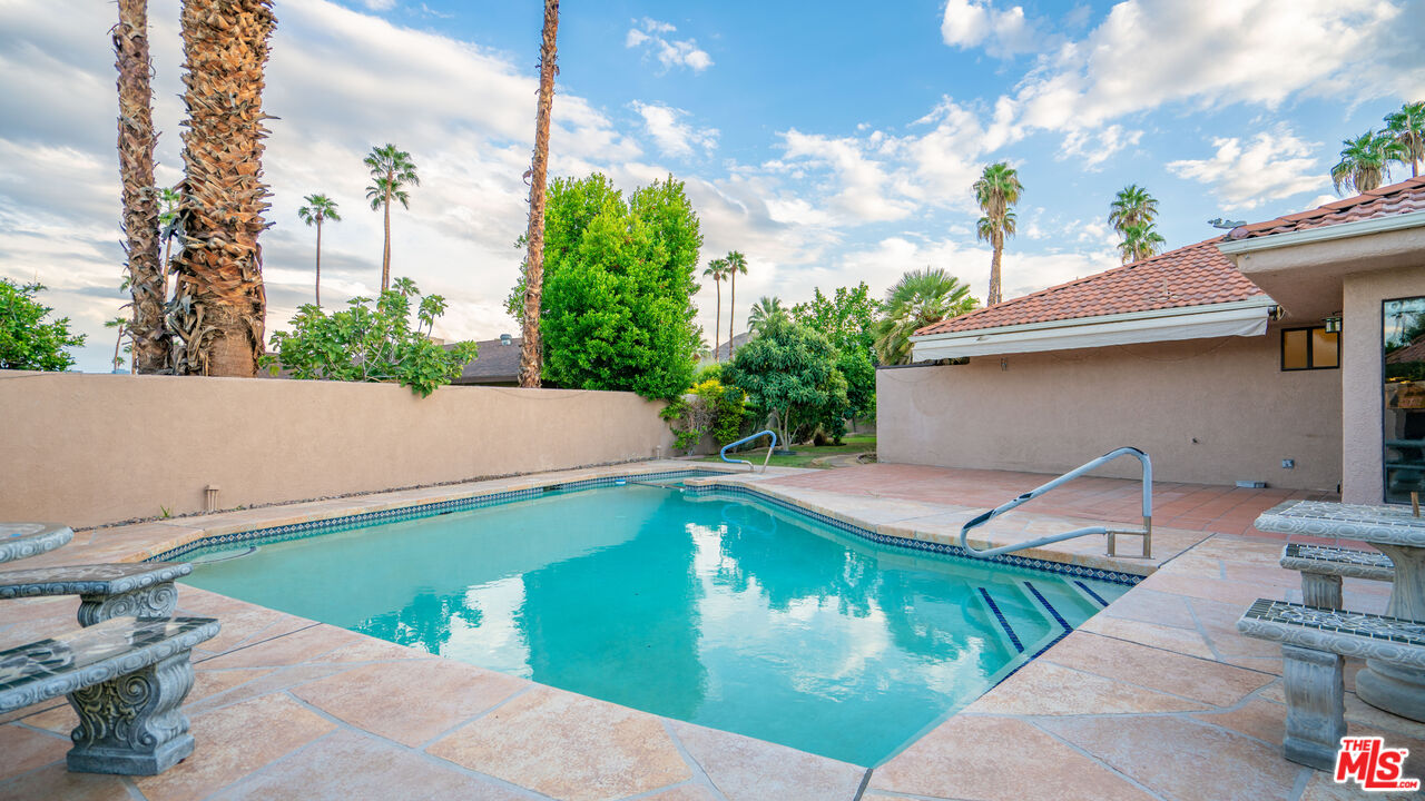 1592 South Compadre Road Palm Springs, CA 92264 - Photo 38 of 53 a view of a swimming pool with a patio
