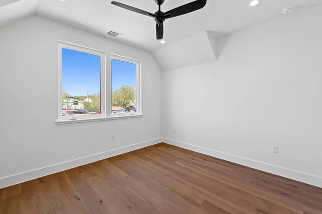 a view of a room with wooden floor and windows