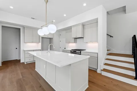 a kitchen with a stove a sink and a refrigerator