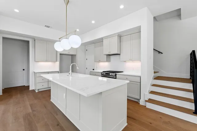 a kitchen with a stove a sink and a refrigerator