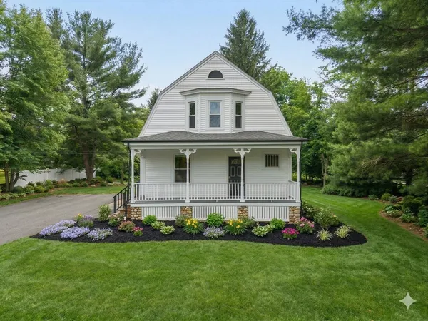 a front view of house with a garden