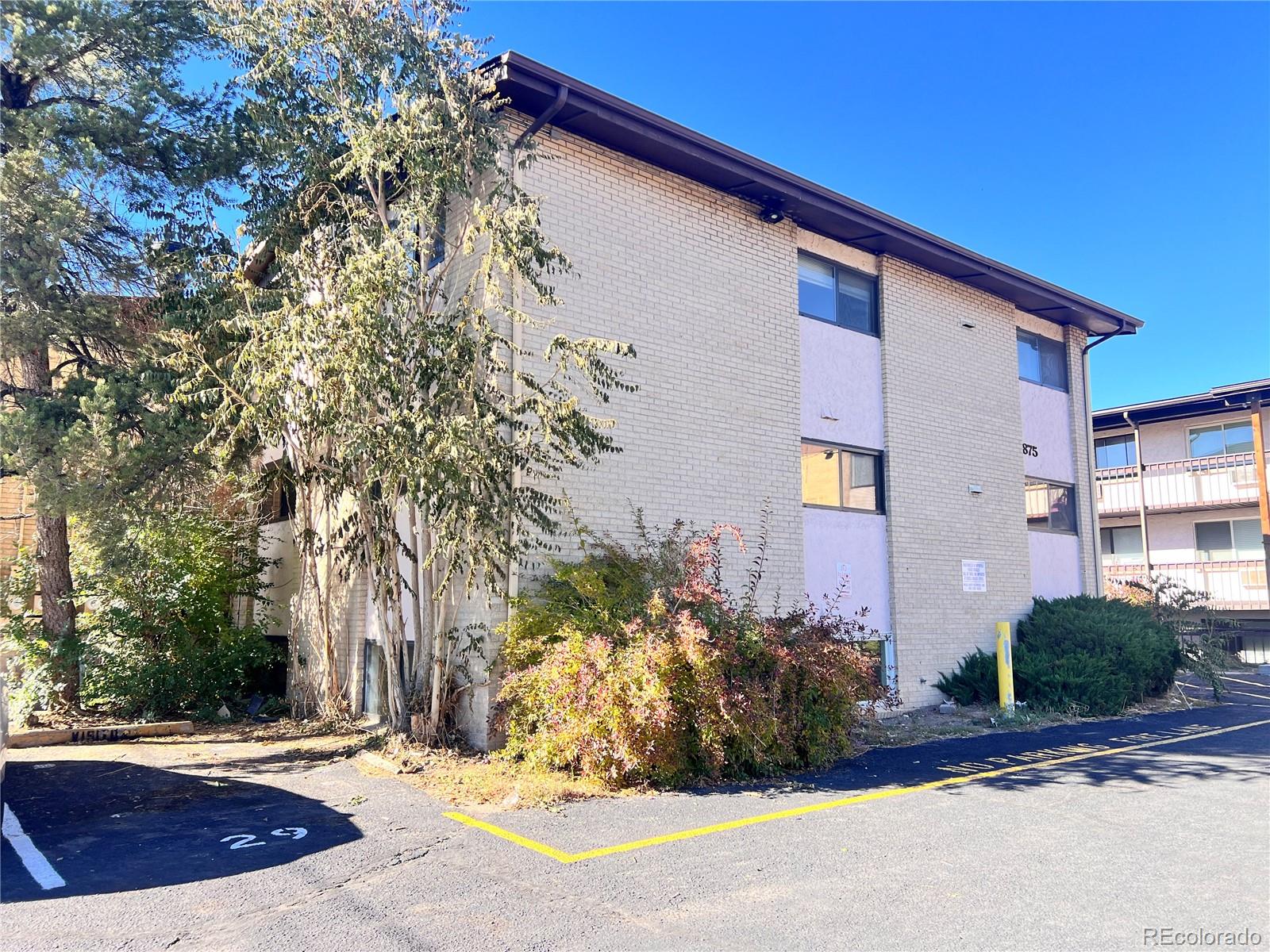 875 South Quebec Street, Unit 29 Denver, CO 80247 - Photo 12 of 13 a view of a house with a yard