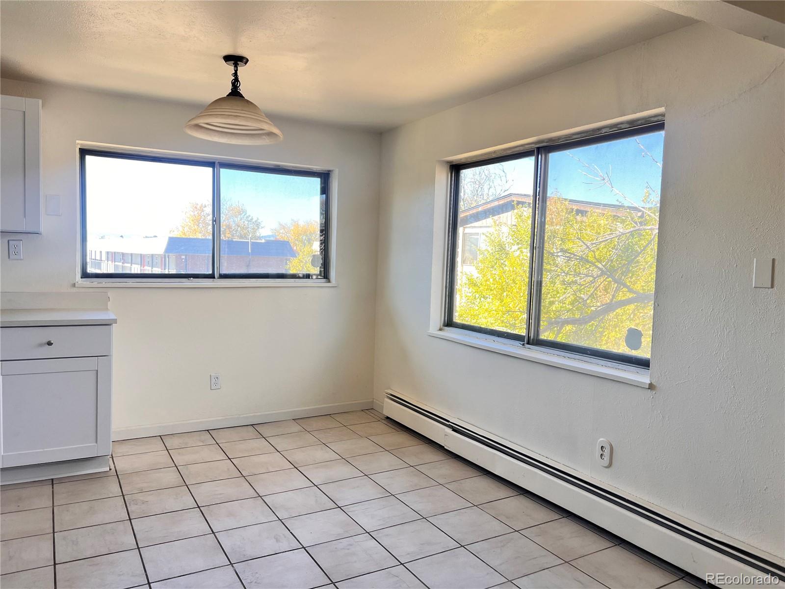 875 South Quebec Street, Unit 29 Denver, CO 80247 - Photo 5 of 13 a view of an empty room with a window